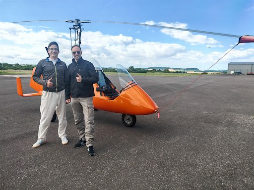 Gäste mit Daumen hoch vor dem Tragschrauber
